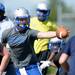 A Lincoln football player reaches out to bring in a wide snap during practice at the school on Wednesday, August 14, 2013. Melanie Maxwell | AnnArbor.com